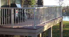 Residential picket aluminum railing photo with a view of a lake by Versadeck Decking